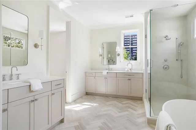 a white tub sitting next to a window