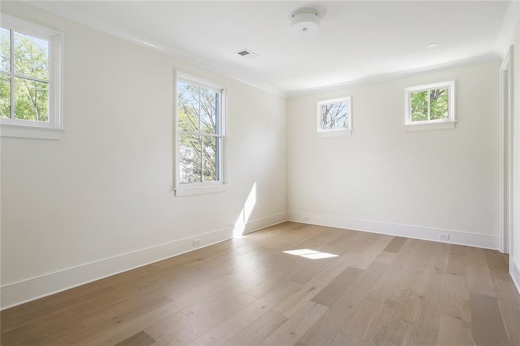 48 25th Atlanta, GA 30328 - Photo 30 of 48 a view of an empty room with a window and wooden floor