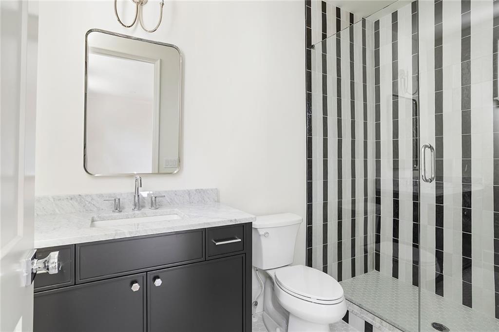 48 25th Atlanta, GA 30328 - Photo 31 of 48 a bathroom with a toilet a sink and a mirror