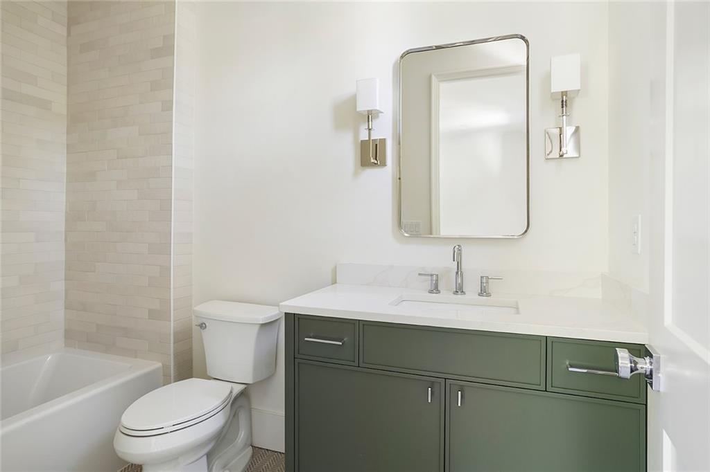 48 25th Atlanta, GA 30328 - Photo 34 of 48 a bathroom with a toilet sink vanity tub and mirror