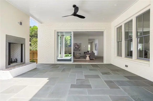 a view of a balcony with a ceiling fan and window