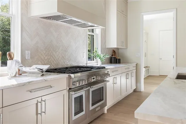 a kitchen with stainless steel appliances granite countertop a stove and a sink