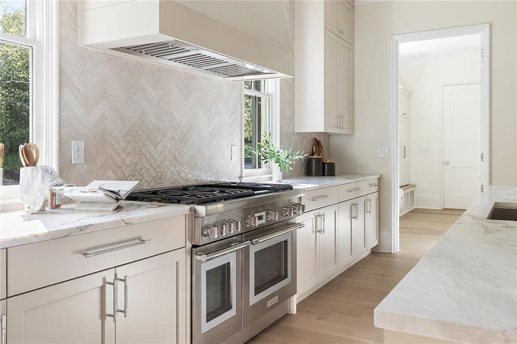 48 25th Atlanta, GA 30328 - Photo 8 of 48 a kitchen with stainless steel appliances granite countertop a stove and a sink