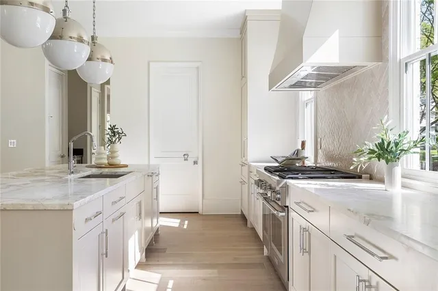 a kitchen with stainless steel appliances granite countertop a sink stove and cabinets