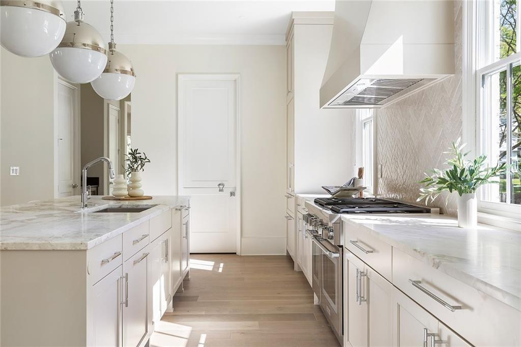 48 25th Atlanta, GA 30328 - Photo 9 of 48 a kitchen with stainless steel appliances granite countertop a sink stove and cabinets