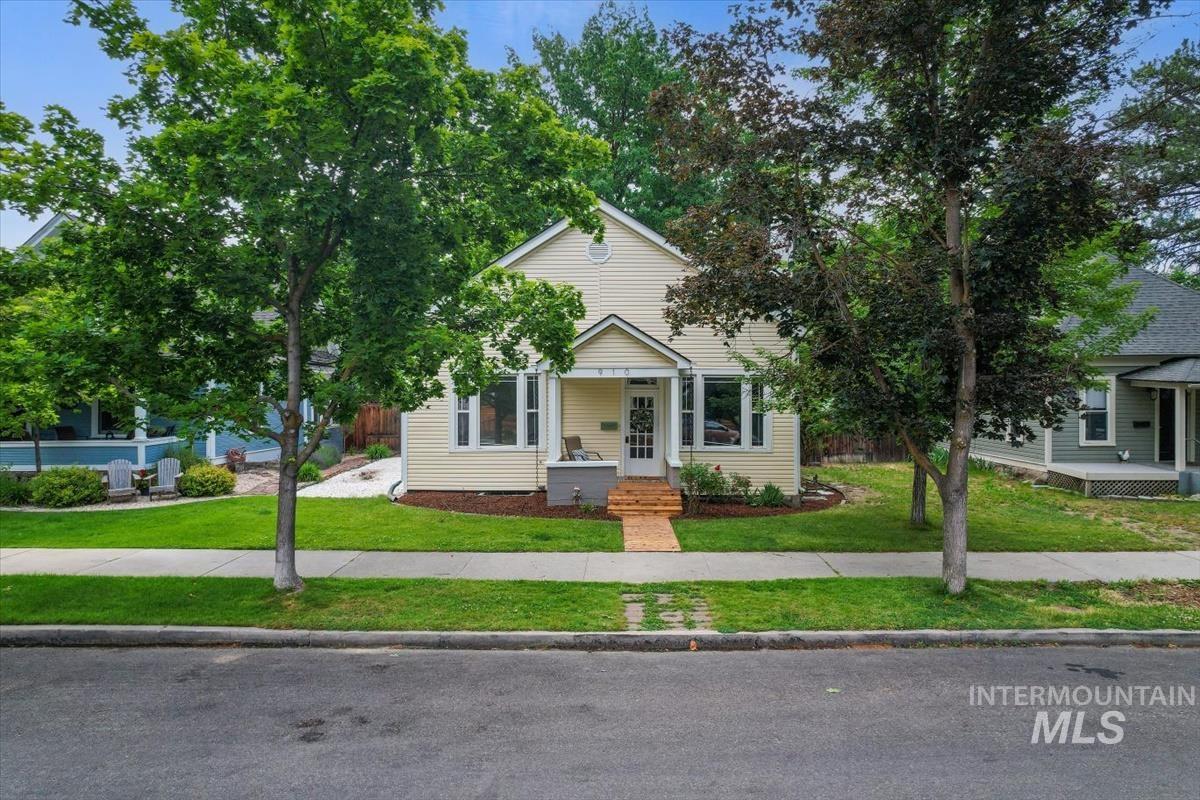 910 North 16th Street Boise, ID 83702 - Photo 39 of 47 Light yellow siding exterior with a covered front porch featuring a brick pathway