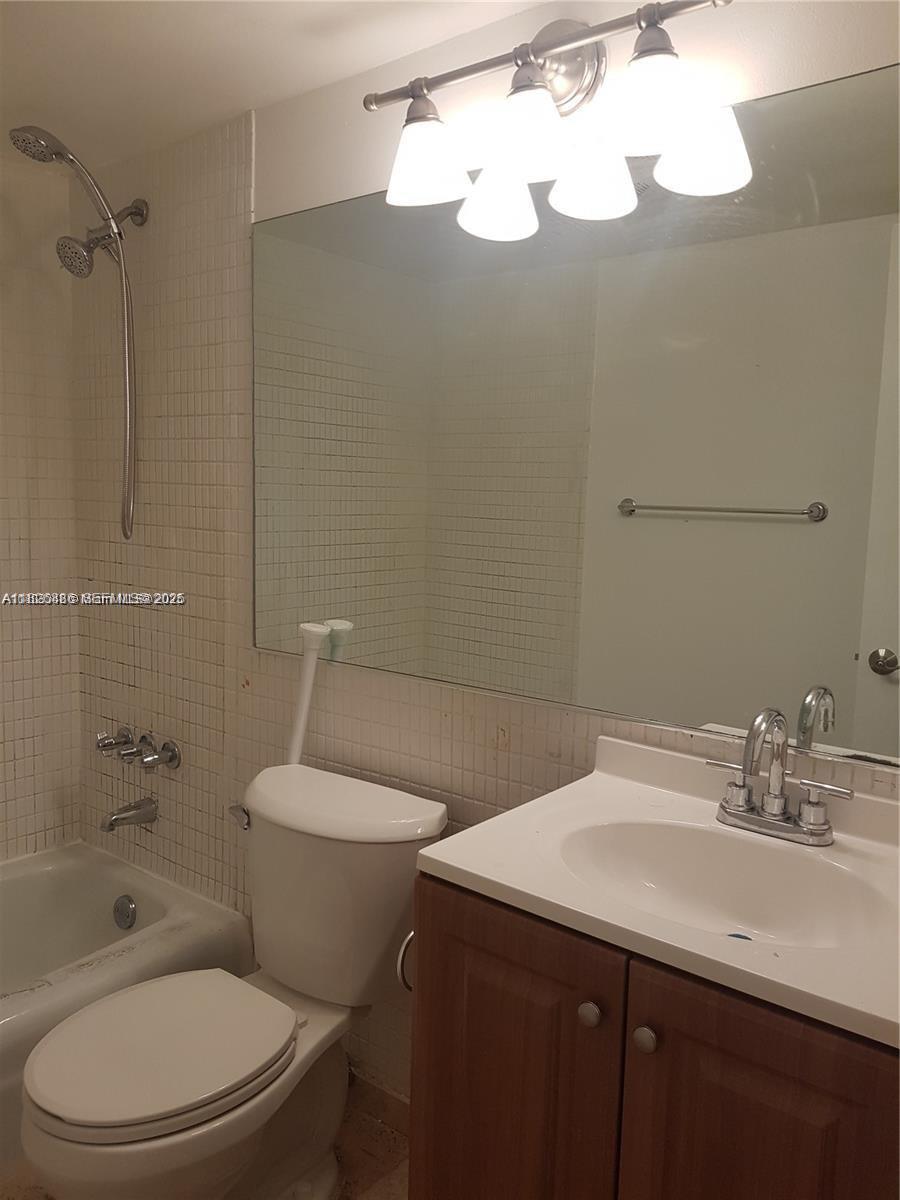 253 South Cypress Road, Unit 237 Pompano Beach, FL 33060 - Photo 16 of 23 a bathroom with a sink a toilet and shower