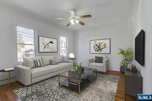 a living room with furniture a flat screen tv and a window