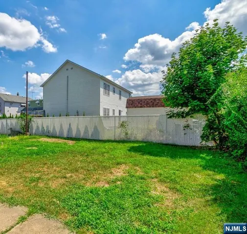 a view of a backyard with plants and a garden