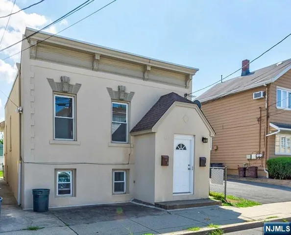 a view of a white house with many windows