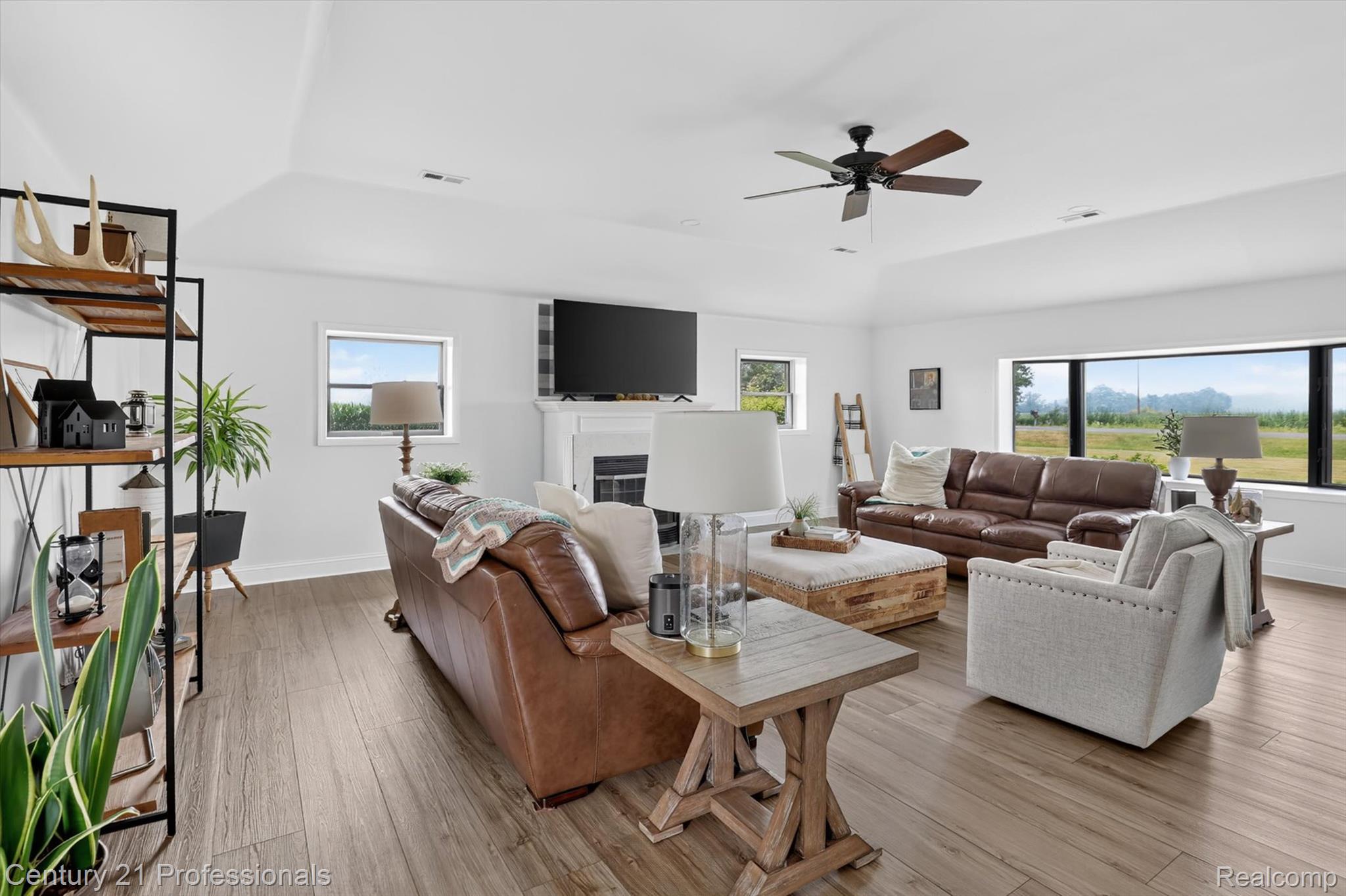 13525 Dennison Road Milan, MI 48160 - Photo 17 of 69 Spacious living area featuring wood-finish flooring, a white vaulted ceiling, and a ceiling fan