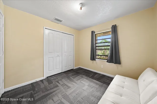 a bed room with a bed and a ceiling fan