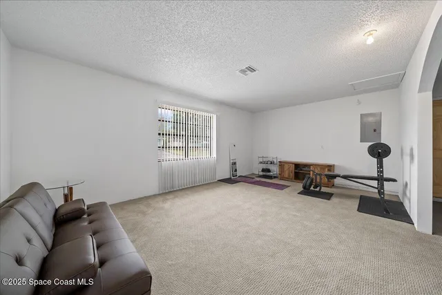 a room with gym equipment and a table