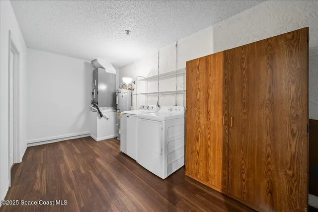 a view of a livingroom with wooden floor and white walls