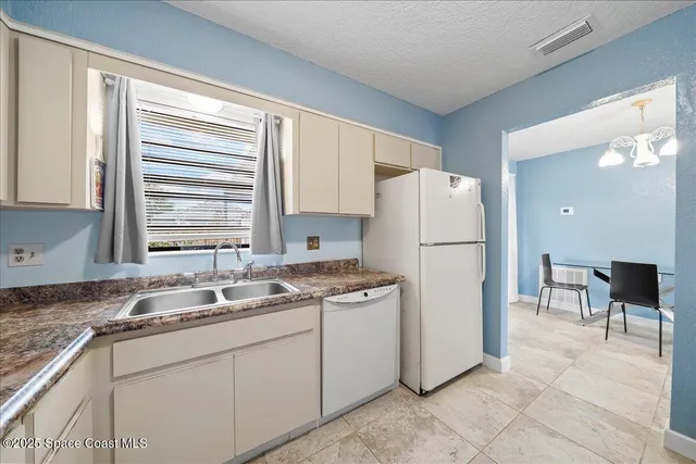 a living room with furniture a chandelier and a window
