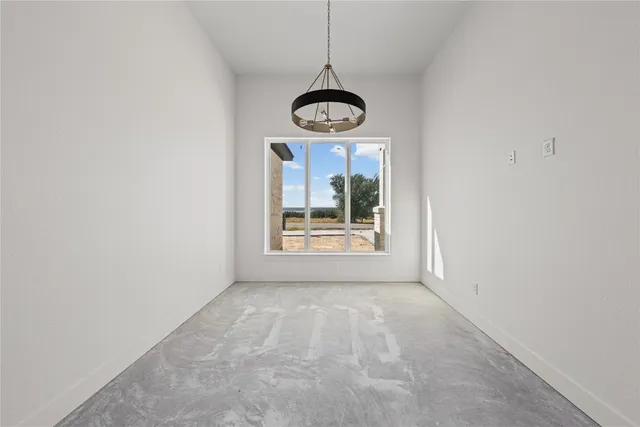 a view of a livingroom with a ceiling fan and window