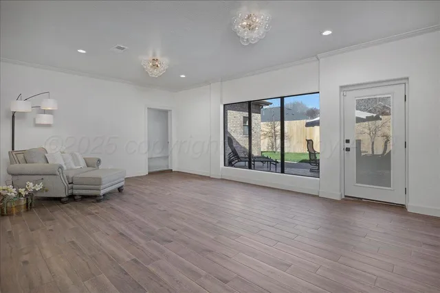 a view of livingroom with furniture wooden floor and windows