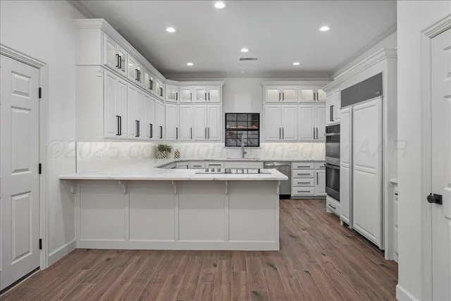 a kitchen with kitchen island cabinets and wooden floor