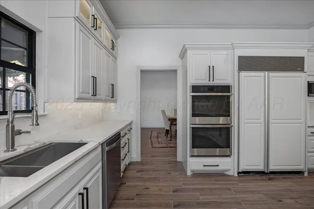 a kitchen with a sink and an oven