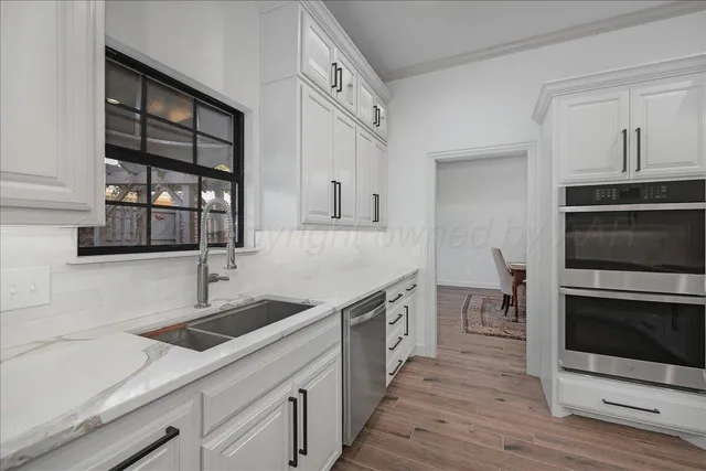 a kitchen with a sink and cabinets