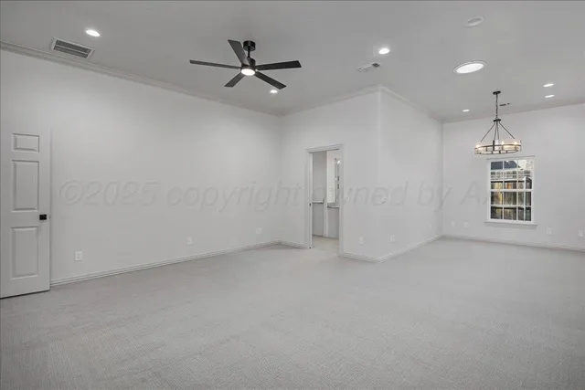 an empty room with a ceiling fan and windows