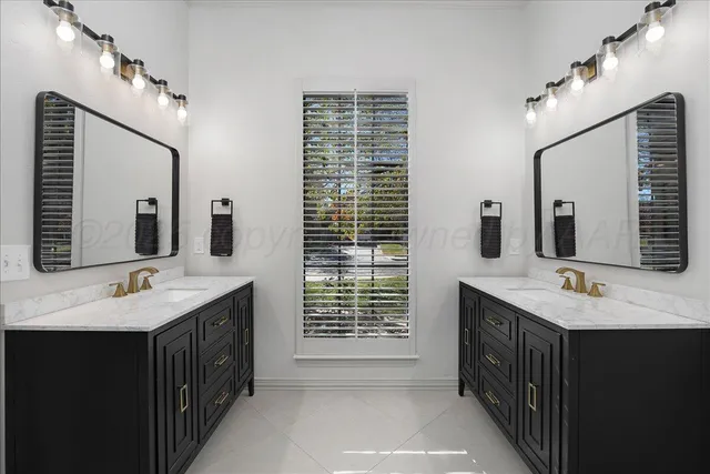 a bathroom with a sink double vanity and a mirror