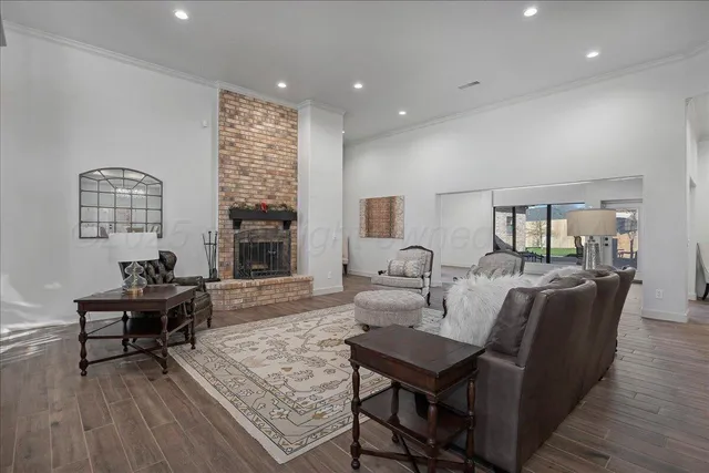 a living room with fireplace furniture and a wooden floor