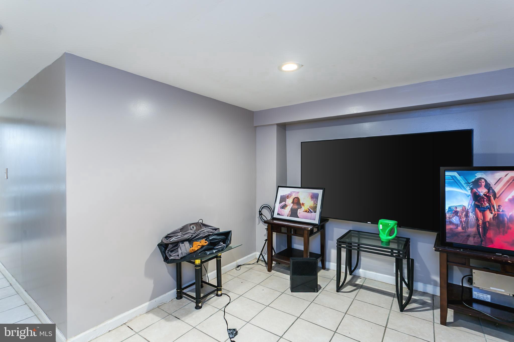5646 Govane Avenue Baltimore, MD 21212 - Photo 13 of 17 a living room with furniture and a flat screen tv