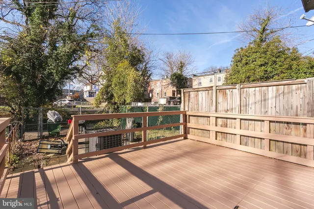 a view of a balcony with wooden floor and fence