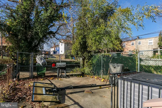 a view of a patio with couches table and chairs and potted plants