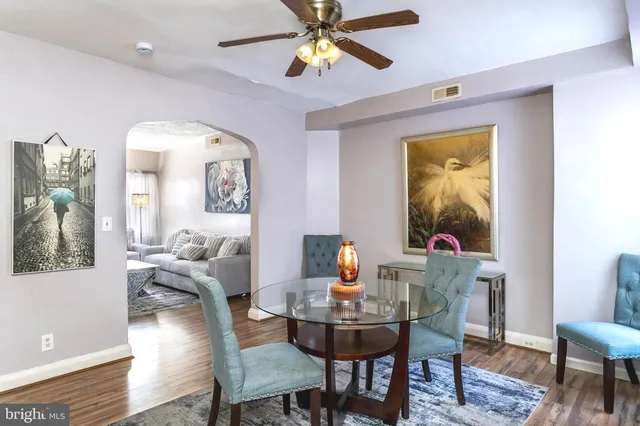 a view of a dining room with furniture and a chandelier