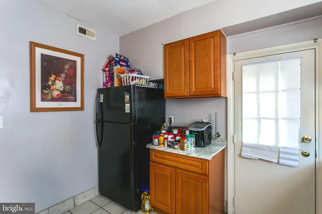 a kitchen with stainless steel appliances granite countertop a refrigerator and a stove