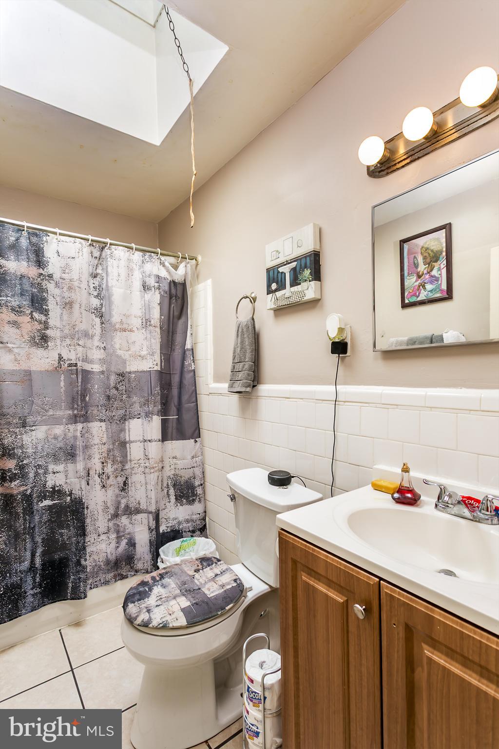 5646 Govane Avenue Baltimore, MD 21212 - Photo 10 of 17 a bathroom with a sink and a mirror