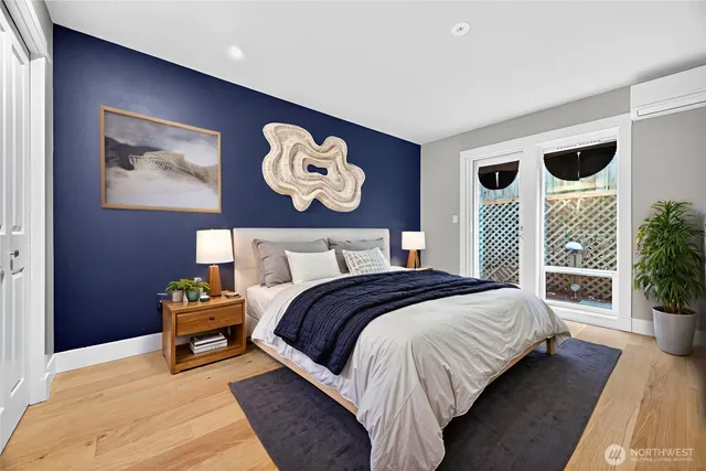 a bedroom with bed and a large mirror