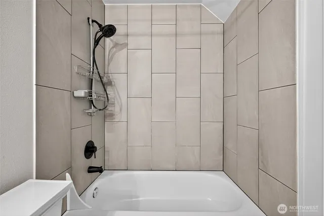 a bathroom with a bath tub and a shower