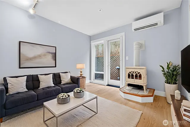 a living room with furniture ceiling fan and a window