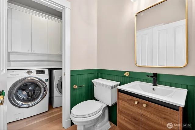 a bathroom with a toilet sink and mirror