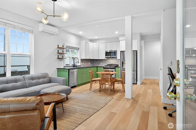 a living room with furniture and kitchen view
