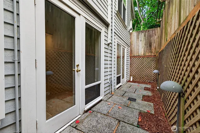 a view of a patio with table and chairs potted plants with wooden fence