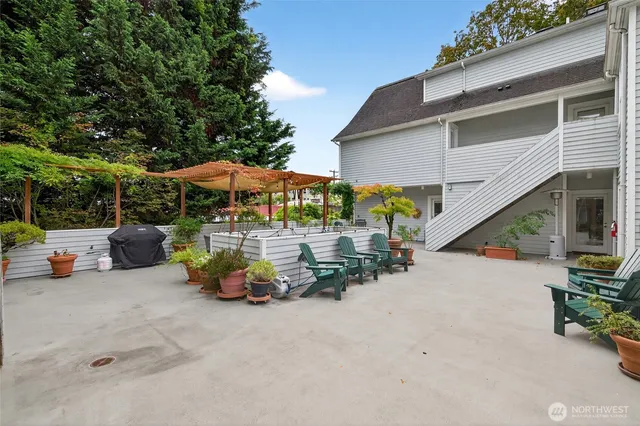 an outdoor space with patio furniture and potted plants