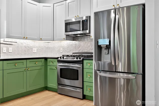 a kitchen with granite countertop a stainless steel appliances and cabinets