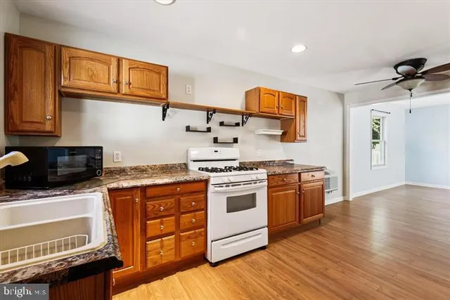 a kitchen with stainless steel appliances a stove a sink and a microwave