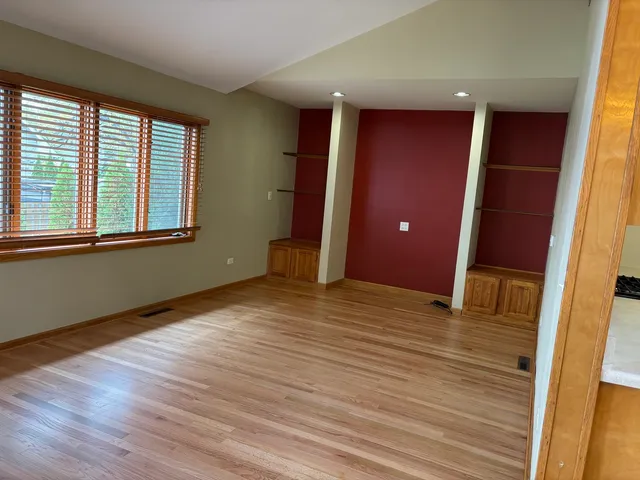 a view of a livingroom with wooden floor and window