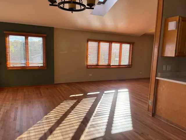 a view of a room with wooden floor and staircase
