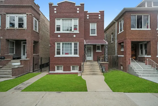 a view of a brick building next to a yard