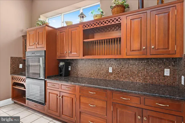 a kitchen with stainless steel appliances granite countertop a stove a sink dishwasher and a refrigerator