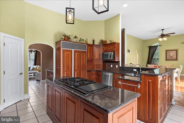 a kitchen with stainless steel appliances a refrigerator and a stove top oven