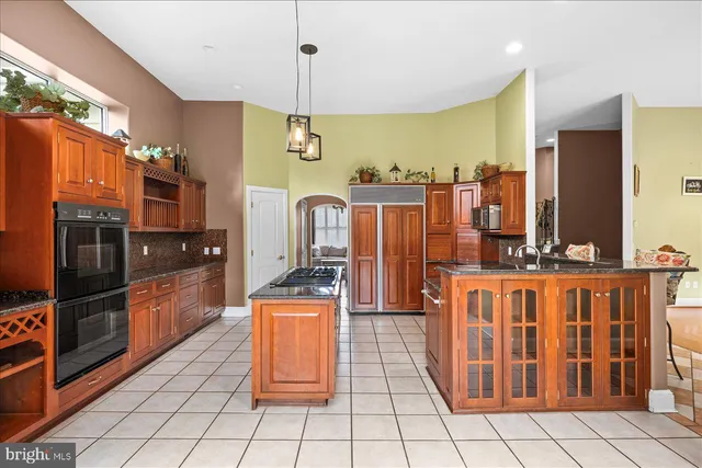 a kitchen with stainless steel appliances granite countertop a cabinets and a stove top oven