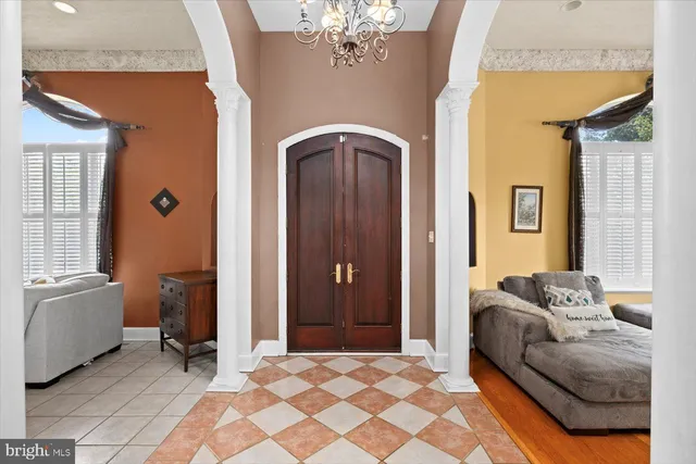 a living room with furniture and a chandelier