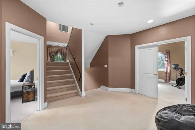 a bedroom with a bed and mirror